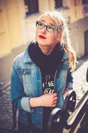Portrait of the blonde woman, with the red lips, and glasses, in light