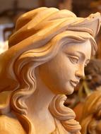 Madonna Wood Carved statue close-up on blurred background