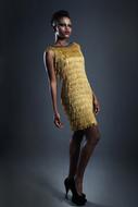 photo of a black model in a gold dress