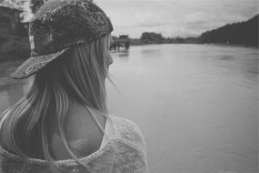 monochrome photo of Young Girl Woman on lake