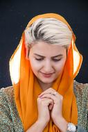blonde woman with orange scarf on head