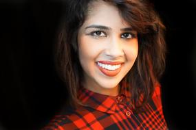 portrait of smiling woman with red lips and in red dress