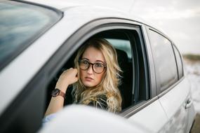 long hair blonde Woman in car at window