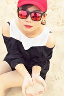 girl in sunglasses on the beach close up
