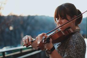 young Woman playing violin outdoor