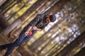 trendy stylish guy in the forest on a blurred background