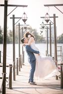 happy newlyweds on pier