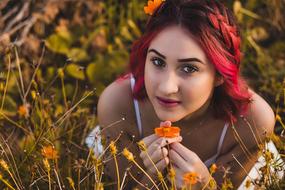 girl with red hair lying on the grass