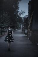 girl in dress walking at dusk