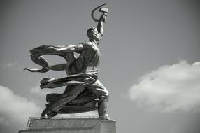 Black and white photo of the beautiful Worker and Kolkhoz Woman, in Moscow, Russia, at sky with clouds