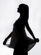 Black silhouette of the girl in dress, posing at white background, clipart