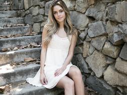 Beautiful Girl Smiling and sitting on stone stairs