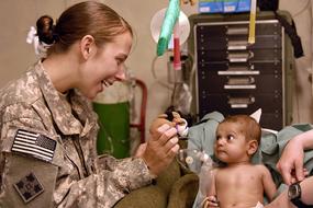 military doctor with a small child