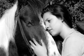 black and white, woman hugs horse