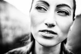 black and white portrait of a girl's face on a blurred background