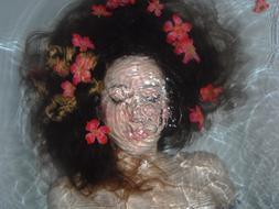 woman underwater with flowers