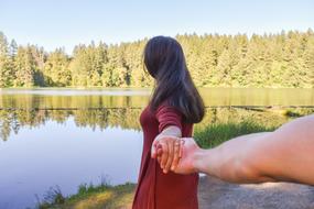 a guy with a girl on the lake during the engagement