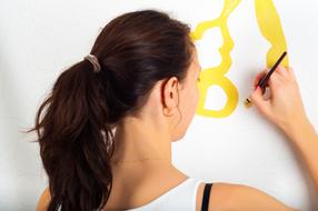 girl artist with a brush in front of a painting