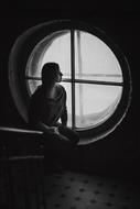 girl near the window in a dark room