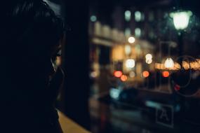 Silhouette of the person, in the city with colorful lights, at the night