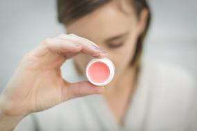 Lip Balm Lipstick Cosmetics in hand