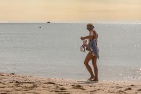 girl with hat on the beach on a sunny day