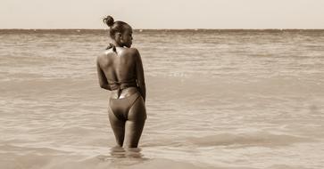 girl at the sea in sepia background