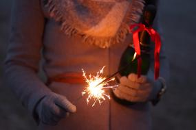 Woman with beautiful fireworks and ribbon in the hands