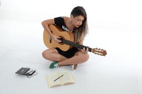 woman with a guitar on the floor