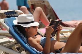 young Woman Reading on beach