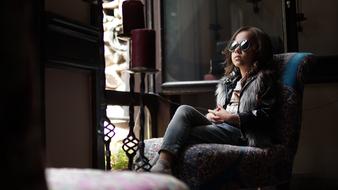 Kid girl sitting on armchair