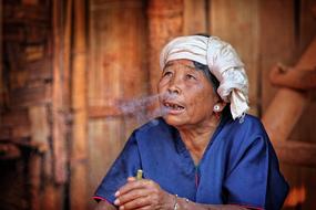 Woman smoking Cigar in Myanmar