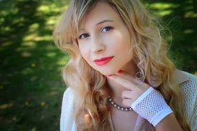 portrait of a blonde with red lips on a blurred background