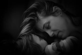 photo of a woman with a child in the dark