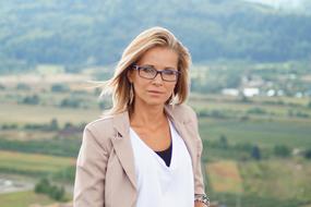 Blonde Woman Girl at background of fields