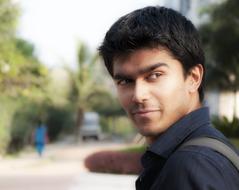 young man on a city street on a blurred background