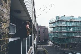 girl standing on the balcony of the building