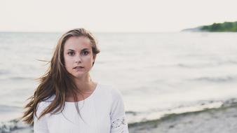 Portrait of the girl in white clothing, on the beautiful beach, with the waves