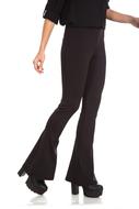 womanâs legs in black bell bottom trousers