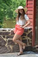 happy girl posing in wide-brimmed hat