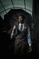 young stylish african Man with umbrella