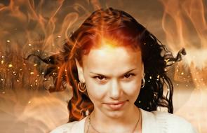 red-haired girl on the background of fire