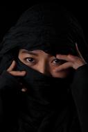 the girl's face is covered with a black hijab