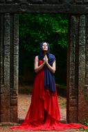 girl in red dress prays in church