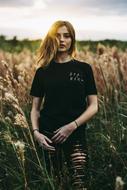 young Woman in black outfit among cane thickets