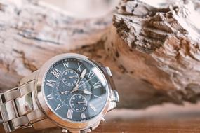 clock on a stone on a blurred background