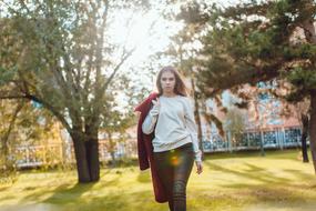 girl with red coat in the park