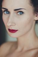Portrait of the woman with make-up and blue eyes, and bare chest