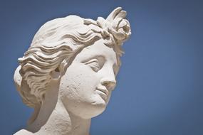 head sculpture against blue sky