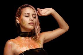 stylish girl doused with orange paint